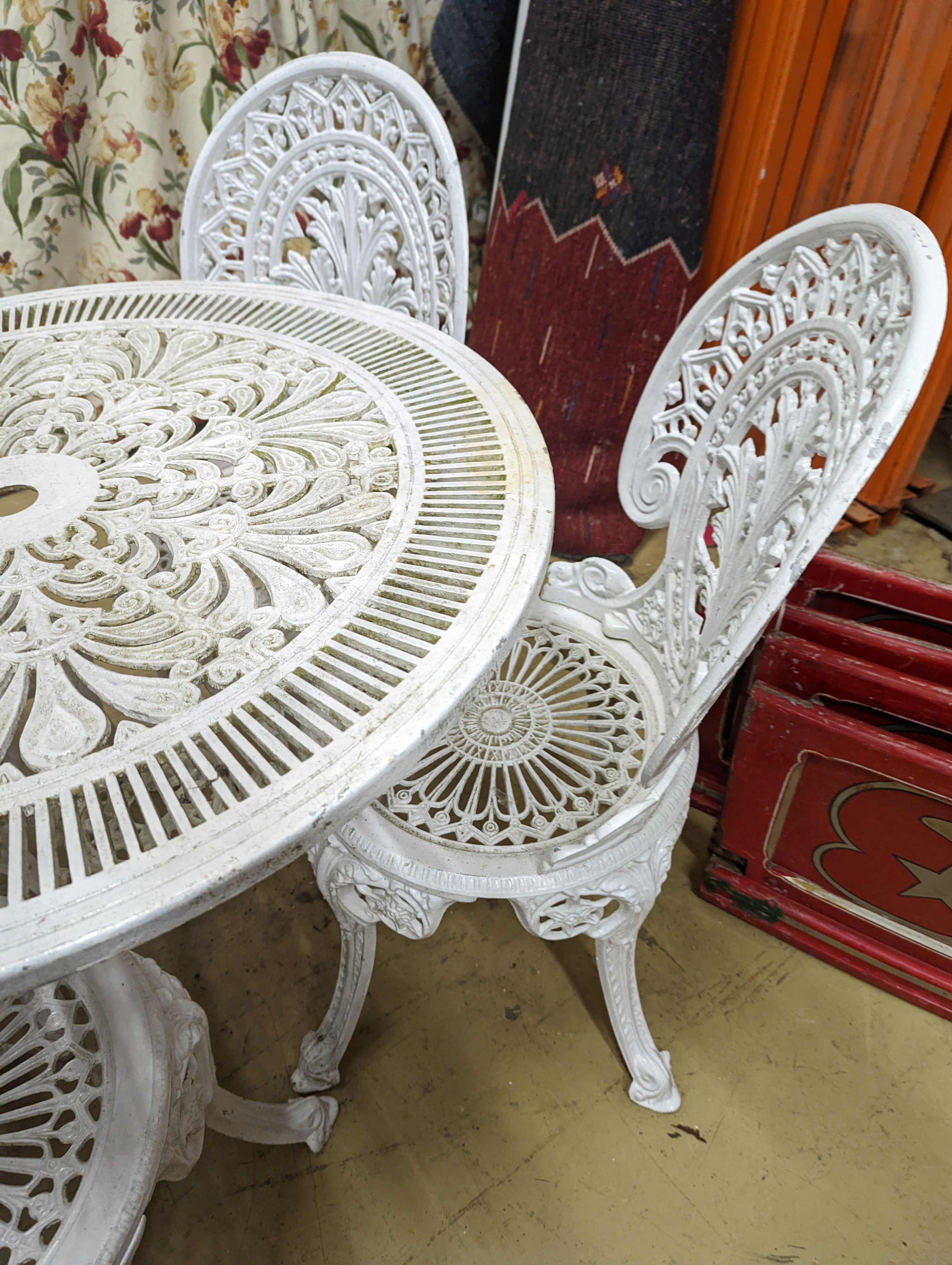 A Victorian style painted aluminium circular garden table, diameter 80cm, height 70cm and four chairs